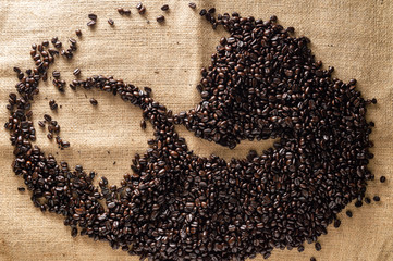  Dark roasted coffee beans on hessian background