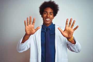 Poster - Young african american doctor man wearing coat standing over isolated white background showing and pointing up with fingers number ten while smiling confident and happy.