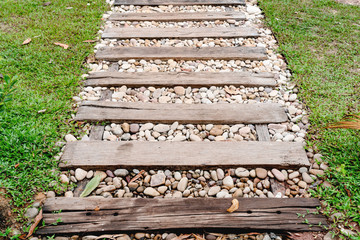 pebble floor and wooden walkway in garden