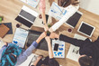 © InfiniteFlow - Businessmen and businesswomen joining hands in group meeting at multicultural office room showing teamwork, support and unity in business. Diversity workplace and corporate people working concept.