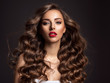 © Valua Vitaly - Beautiful woman with long brown hair and red lipstick.