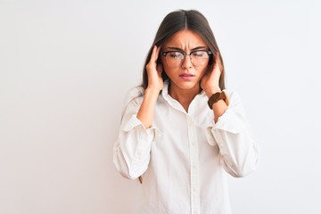 Wall Mural - Young beautiful businesswoman wearing glasses standing over isolated white background with hand on headache because stress. Suffering migraine.