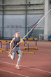 © KONSTANTIN SHISHKIN - Pole vaulting - pretty woman is running with long pole
