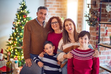 Beautiful family smiling happy and confident. Standing and posing around christmas treeat home