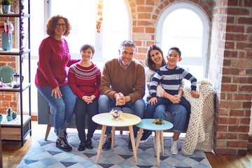 Beautiful family smiling happy and confident. Sitting on the sofa and posing celebrating christmas at home