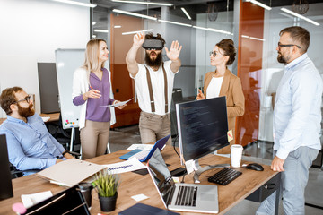 Wall Mural - group of diverse colleagues during small conference in the office, creative bearded man trying a new
