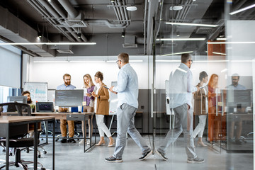 Wall Mural - interior view on the modern office room with diverse people working on the computers indoors