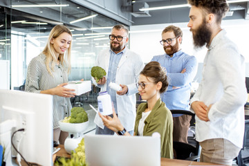 Wall Mural - group of diverse people working on a new eco product or dietary supplement in the office. branding a