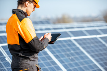 Wall Mural - engineer servicing solar panel on electric plant