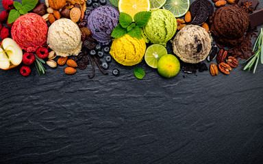 Fototapete - Various of ice cream flavor ball blueberry ,lime ,pistachio ,almond ,orange ,chocolate and vanilla set up on dark stone background . Summer and Sweet menu concept.