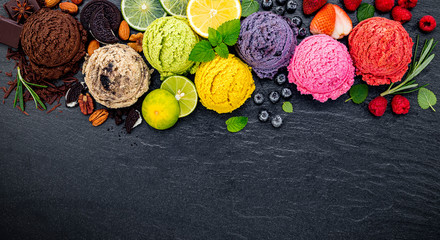 Fototapete - Various of ice cream flavor ball blueberry ,lime ,pistachio ,almond ,orange ,chocolate and vanilla set up on dark stone background . Summer and Sweet menu concept.