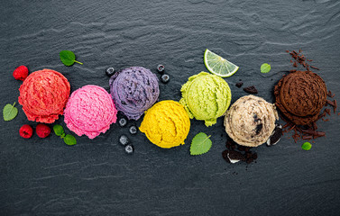 Fototapete - Various of ice cream flavor ball blueberry ,lime ,pistachio ,almond ,orange ,chocolate and vanilla set up on dark stone background . Summer and Sweet menu concept.