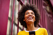 © mimagephotos - Close up of beautiful young african american woman smiling outside