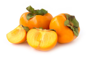 Wall Mural - Closeup fresh orange organic ripe Fuyu Persimmons or Persimon fruits with sliced isolated on white background.