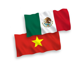 National vector fabric wave flags of Mexico and Vietnam isolated on white background. 1 to 2 proportion.