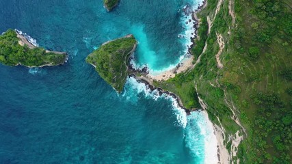 Wall Mural - Aerial view at sea and rocks. Turquoise water background from top view. Summer seascape from air. Atuh beach, Nusa Penida, Bali, Indonesia. Travel - video