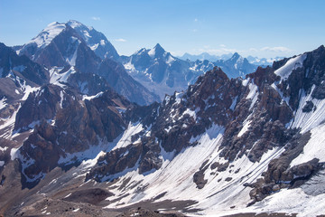 Canvas Print - Wild snowy mountain range. Mountains landscape. Climbing in highlands. View from Chimtarga peak in Fann mountains, Tajikistan
