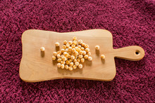 Dried Peas On A Wooden Board. Peas Are An Herbaceous Plant In The Legume Family. There Are Beans In Bivalve Pods.