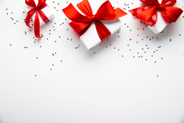Wall Mural - white gifts with red ribbon, present on white background top view. merry christmas and happy holiday