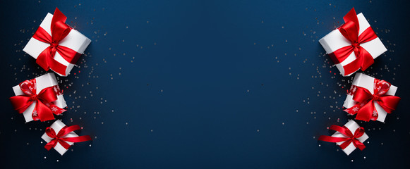 merry christmas ornaments and gift on blue background top view. xmas and new year holiday theme. fla