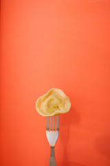 Wall Mural - Dumplings on a fork, orange background