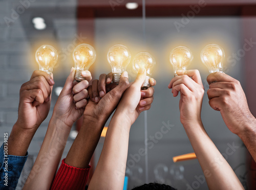 Cuadros en Lienzo Teamwork and brainstorming concept with businessmen that share an idea with a lamp