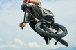 Bmx rider is making extreme stunts.