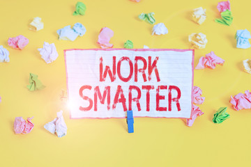 Conceptual hand writing showing Work Smarter. Concept meaning figuring out order to reach goals in the most efficient way Colored crumpled paper empty reminder white floor clothespin