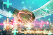 © Andrey - Double exposure of heart drawing on city view background with handshake. Concept of medical education