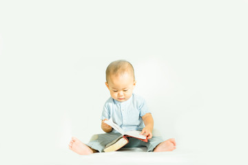 Cute asian baby boy read on a Holy Bible for faith and bible study and teach kid in the way of GOD.Concept for faith, spirituality and religion.