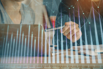 Forex graph with businessman typing on computer in office on background. Concept of analysis. Double exposure.