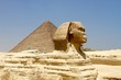 Profile of the sphinx with Giza pyramids on the background, Cairo, Egypt 