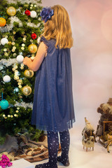 Sticker - beautiful little girl decorating the Christmas tree