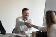 © fizkes - Excited businessman handshake colleague greeting at meeting