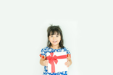 Wall Mural - Little asian girl smile and holding red gift box on white background.child holding gift box.