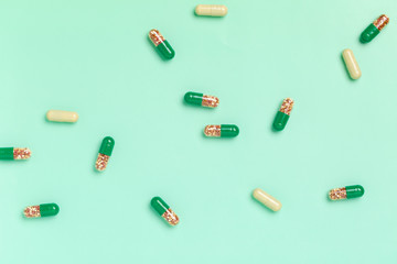 Wall Mural - Colorful medicine capsules on a single color background