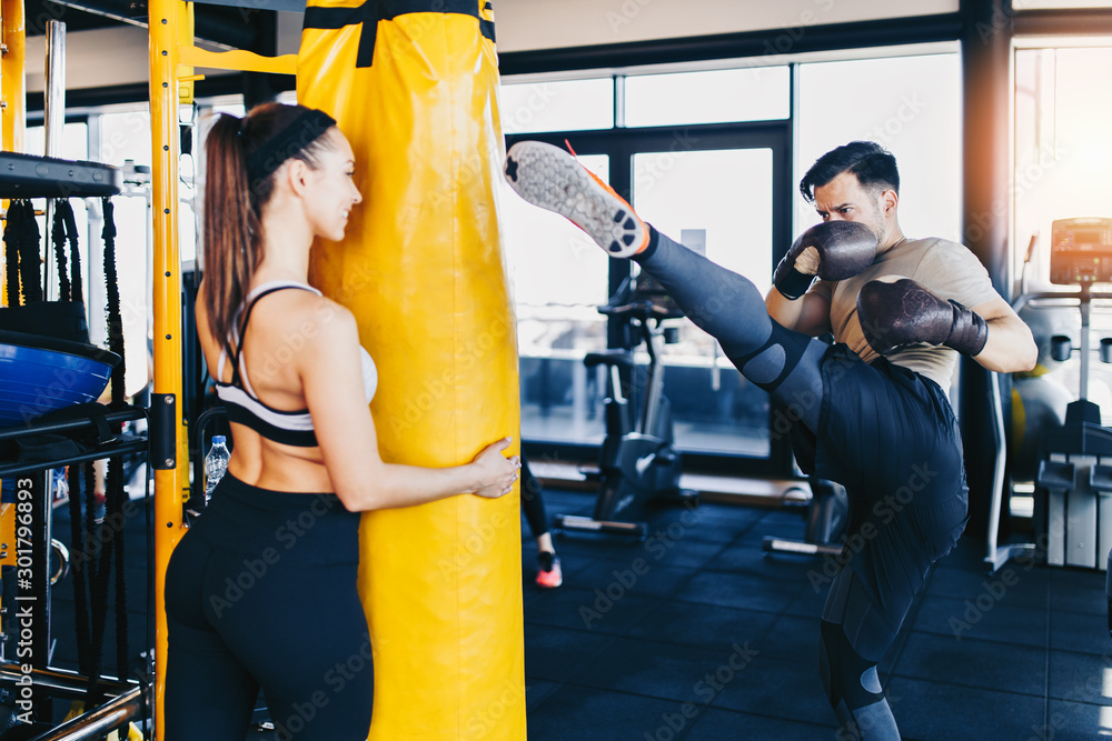 фотографія Young attractive woman with instructor on kickboxing training
