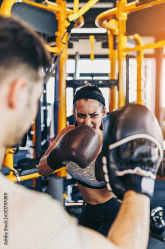 Принти на полотні Young attractive woman with instructor on kickboxing training