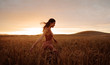 © Jacob Lund - Carefree female strolling in the wheat field