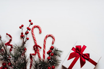 Wall Mural - Christmas background with Christmas gift, fir branches, pine cones, snowflakes, red decorations. Xmas and Happy New Year composition. Place for text. Flat lay, top view