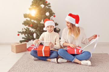 Wall Mural - Single parent and holidays concept - Portrait of mother and son celebrating christmas at home on christmas eve