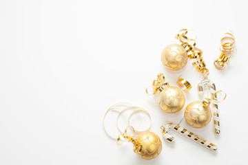 christmas background for text is white, decorated with gold christmas tree toys, gold ribbons and ca