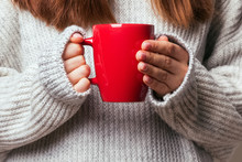 Picture Of A Woman's Hand Holding A Red Coffee Mug