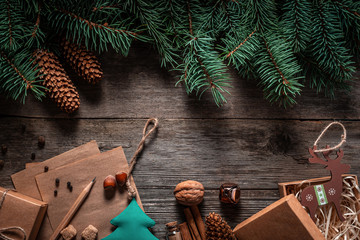 Wall Mural - Christmas green frame from fir branches on a vintage gray board background. Frame of fir branches. Christmas card blank.