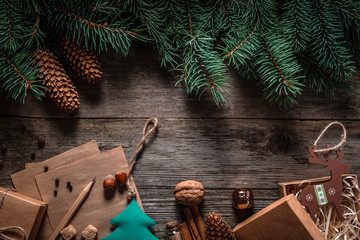 Wall Mural - Christmas green frame from fir branches on a vintage gray board background. Frame of fir branches. Christmas card blank.