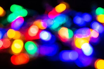 Blurry multicolored garland with glowing lights. Christmas, new year, birthday and wedding concept .