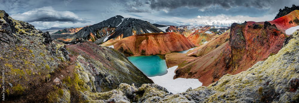 Panoramic view of colorful rhyolite volcanic mountains Landmannalaugar as pure wilderness in Iceland and a hidden highland lake, Iceland - obrazy, fototapety, plakaty 