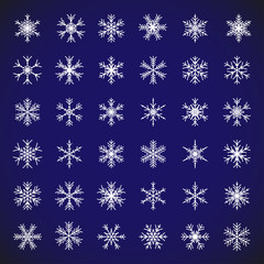 Poster - White snow symbol. Vector set of isolated snowflakes. Collection of white snow flakes on blue background for christmas and new year holiday illustrations. Abstract vector snowflake icon symbols.
