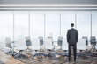 © Who is Danny - Businessman standing in luxury conference room