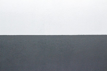 background texture of a plastered wall painted white-gray on two horizontal parts. bottom gray, top white